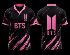 Front and back view of a black and pink BTS V-neck polo jersey featuring dynamic pink brushstroke graphics and a clean BTS logo on the back without a number.