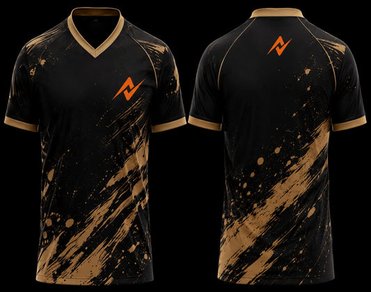 Front and back view of a black and gold V-neck cricket jersey featuring bold paint splatter graphics with an orange chest logo and upper back logo.