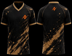 Front and back view of a black and gold V-neck cricket jersey featuring bold paint splatter graphics with an orange chest logo and upper back logo.