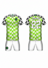 Custom green and white zigzag football jersey with matching white shorts and black patterned sleeves for soccer and team sports by NextPrint India