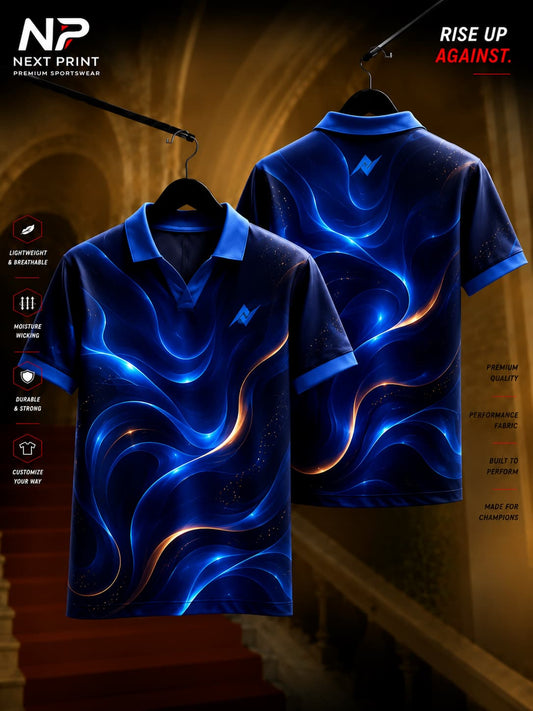 Next Print Cosmic Wave navy blue polo collar V-neck cricket jersey featuring glowing blue and gold abstract wave graphics with front and back views.