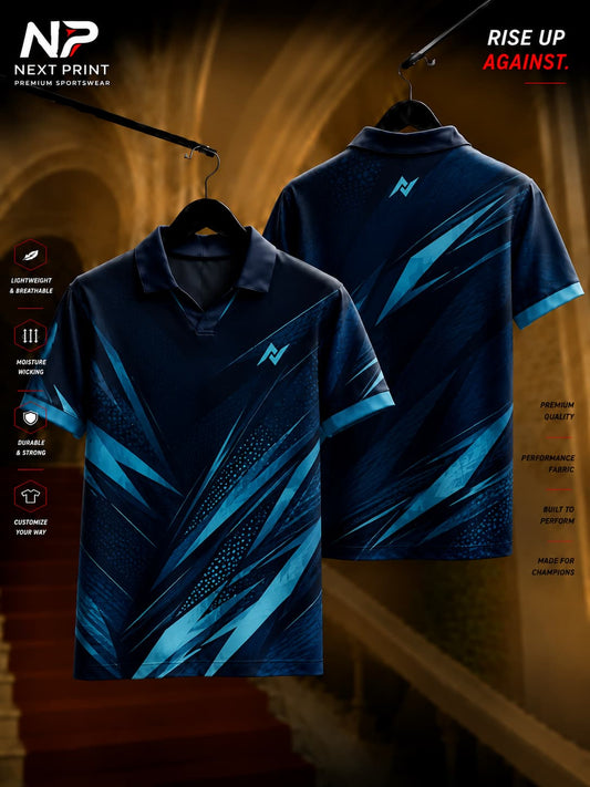 Next Print Midnight Velocity navy blue polo collar V-neck cricket jersey with electric blue geometric design shown from front and back.